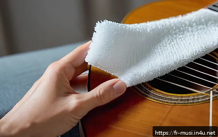 기타 스트링 교체 방법 - A close-up scene of a person carefully cleaning the neck and body of a classical guitar with a soft,...